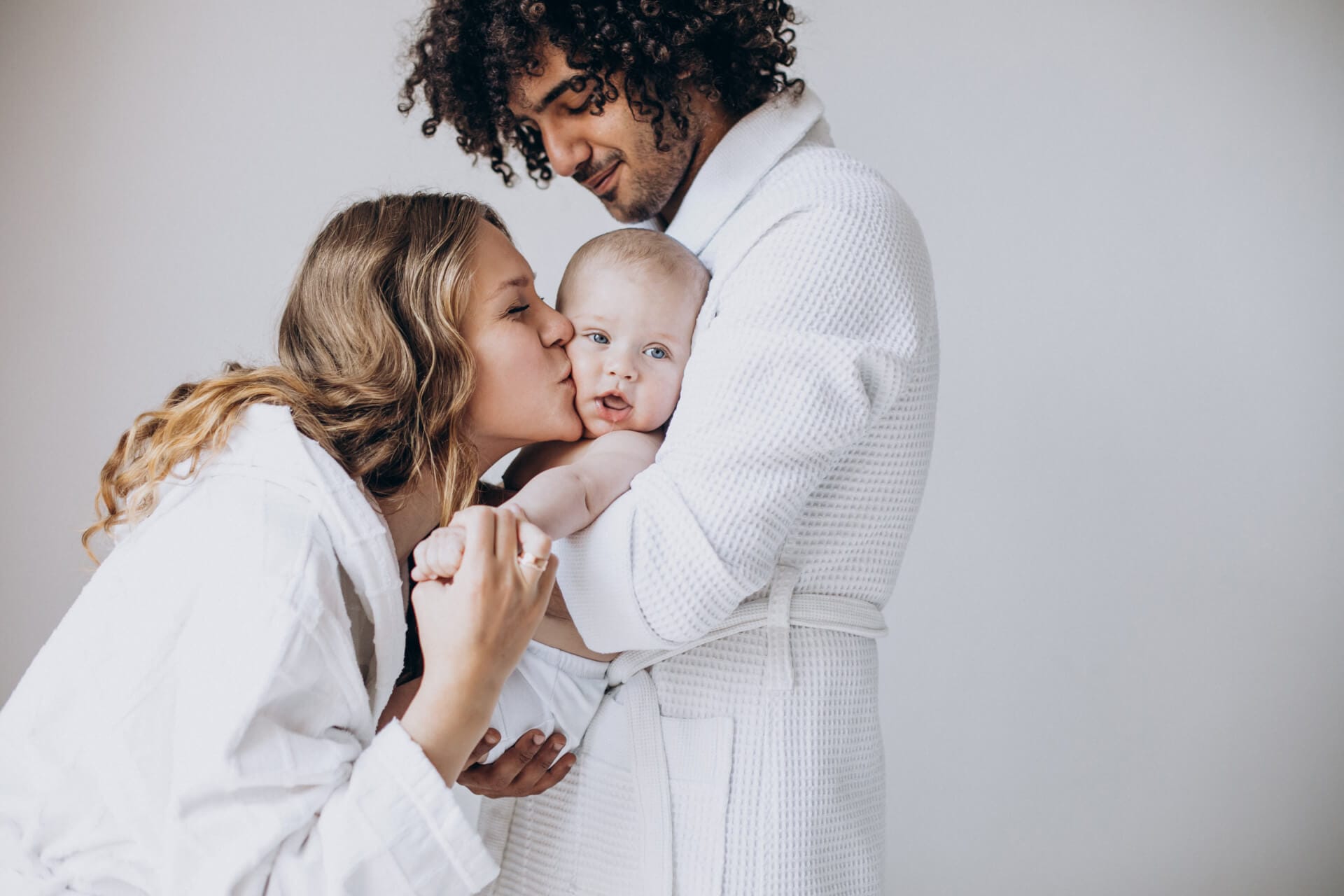 Multicultural family with their little son having fun together